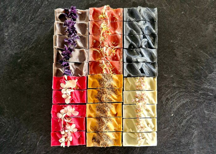 Fatglow handmade tallow soaps arranged artistically to highlight natural colours and botanicals