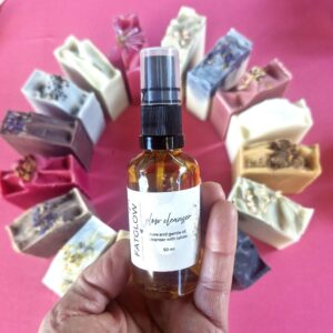 Fatglow Tallow Glow Cleanser framed above a circle of handmade tallow soaps