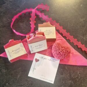 Fatglow Valentine's gift pack featuring a heart shaped soap and three bar soaps in soft pink tones. A quiet considered display reflecting intention, care and mindful giving.
