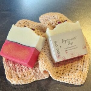 Handcrafted Tallow Peppermint & Rose soap with a pink botantical base and a creamy white top