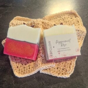 Handcrafted Tallow Peppermint & Rose soap with a pink botantical base and a creamy white top