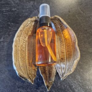 Botanical glow serum in a soap dish, formulated with grass-fed tallow and cold pressed botanicals