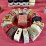 Fatglow tallow soap collection, handcrafted in Taranaki, New Zealand with botanical skincare in the background