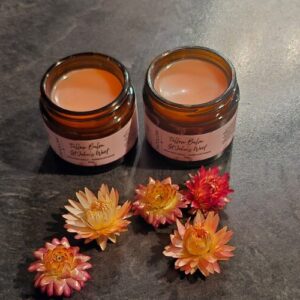 Fatglow St John's Wort tallow balm showing deep red colour from botanical infusion, handcrafted in Taranaki, New Zealand
